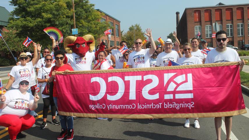 博彩网站 community members marching in Puerto Rican Day Parade